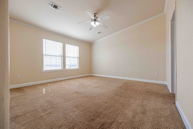 carpeted spare room with a textured ceiling, ceiling fan, and crown molding