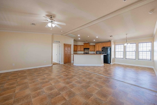 kitchen with black refrigerator, ceiling fan with notable chandelier, lofted ceiling with beams, decorative light fixtures, and a center island