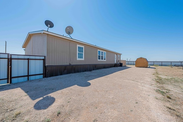 rear view of property featuring a shed