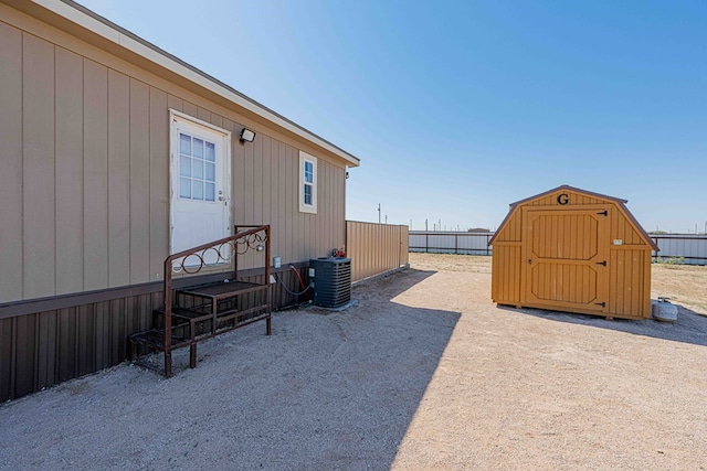 view of patio featuring a storage unit and cooling unit