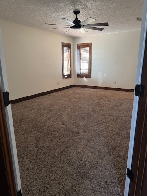 carpeted spare room featuring a textured ceiling