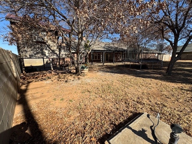 view of yard featuring a patio and a trampoline