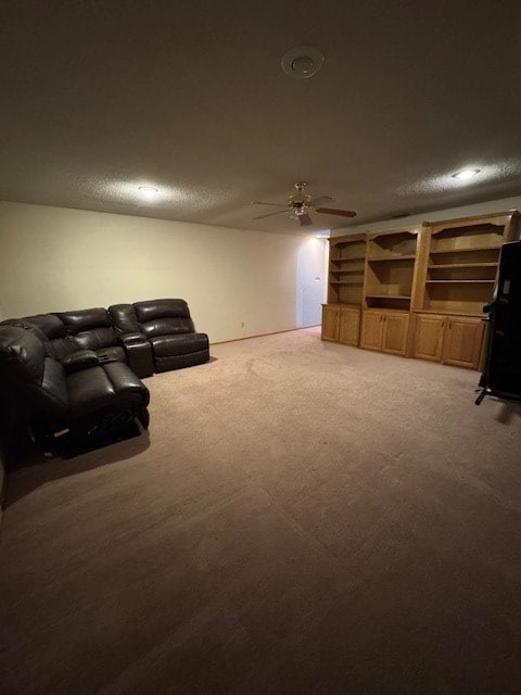 living room with ceiling fan, carpet, and a textured ceiling