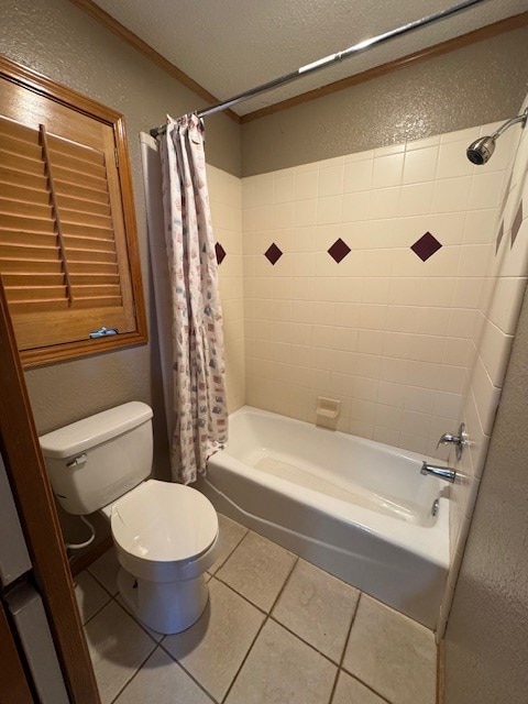 bathroom with tile patterned flooring, a textured ceiling, shower / tub combo with curtain, and toilet