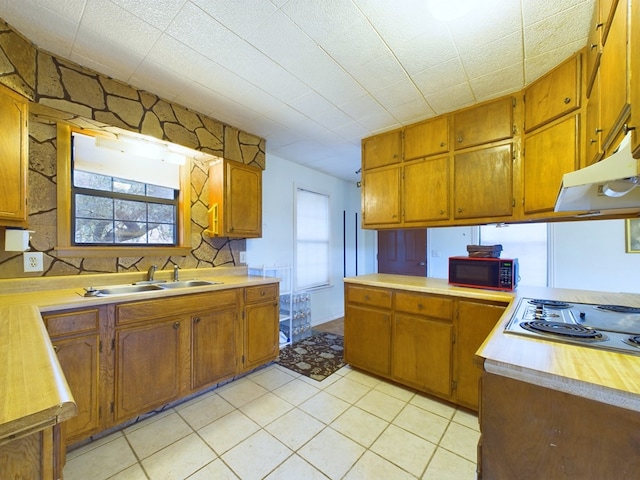 kitchen with sink, light tile patterned floors, and gas stovetop