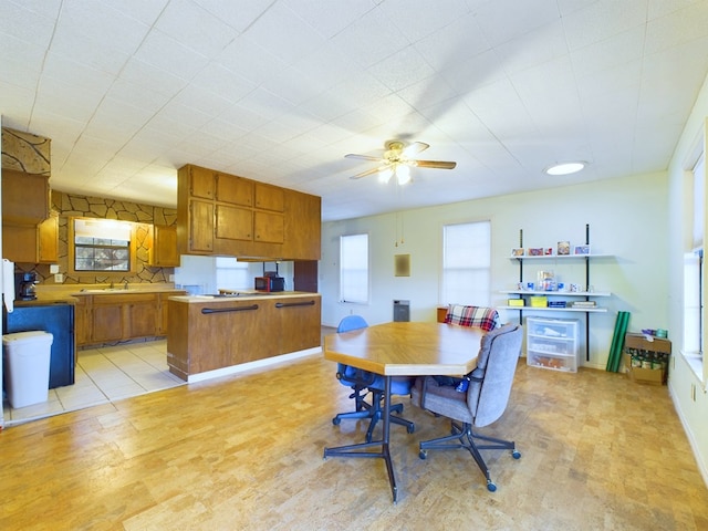 dining area featuring ceiling fan and sink