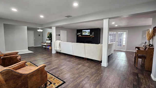 living room featuring a chandelier and dark hardwood / wood-style floors