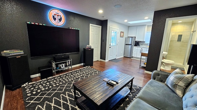 living room featuring a textured ceiling and dark wood-type flooring