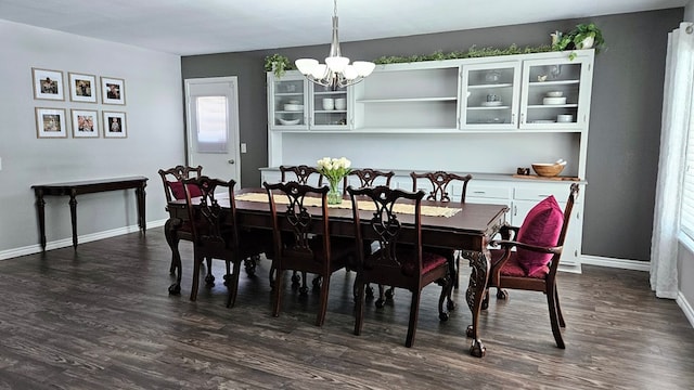 dining room featuring dark hardwood / wood-style flooring and an inviting chandelier