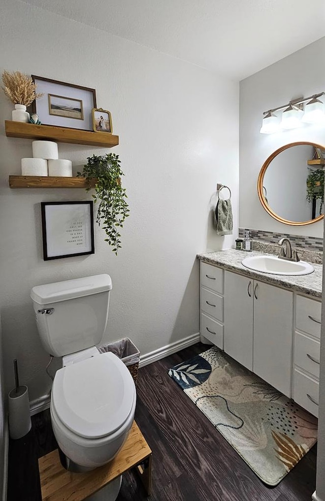 bathroom featuring hardwood / wood-style flooring, vanity, and toilet