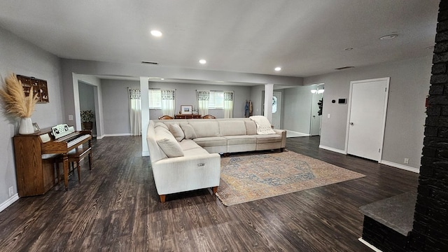 living room featuring ornate columns and dark hardwood / wood-style flooring