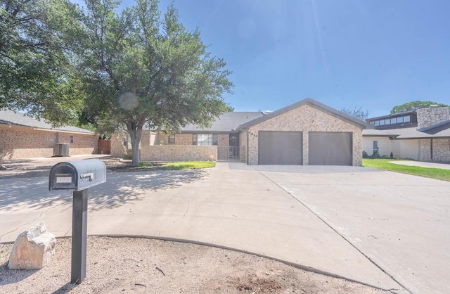 view of front of property featuring cooling unit and a garage