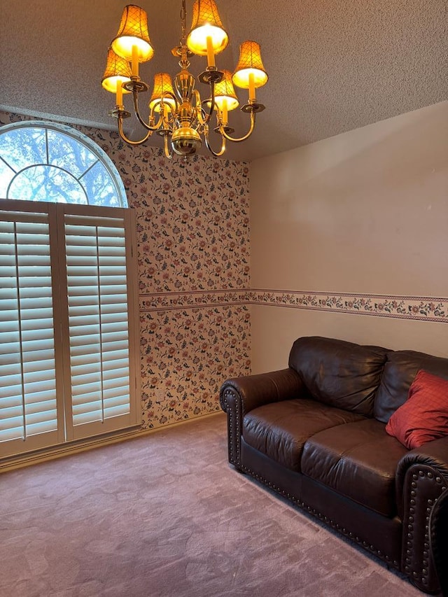 living room with a chandelier, a textured ceiling, and carpet flooring