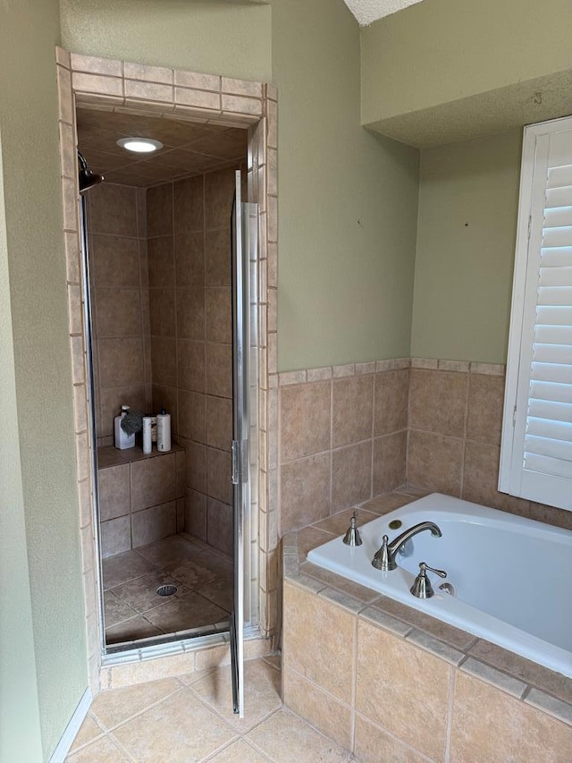 bathroom featuring independent shower and bath and tile patterned floors