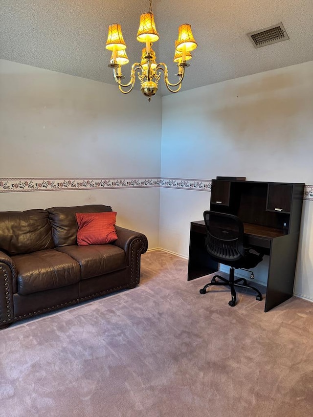 carpeted home office featuring a notable chandelier and a textured ceiling