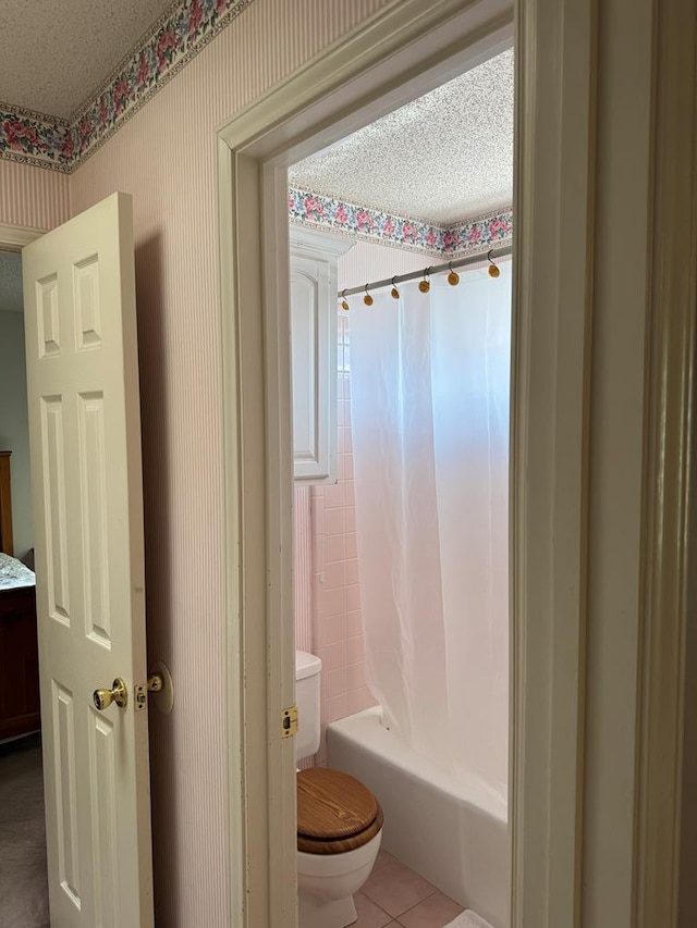 bathroom with toilet, tile patterned floors, shower / bath combination with curtain, and a textured ceiling