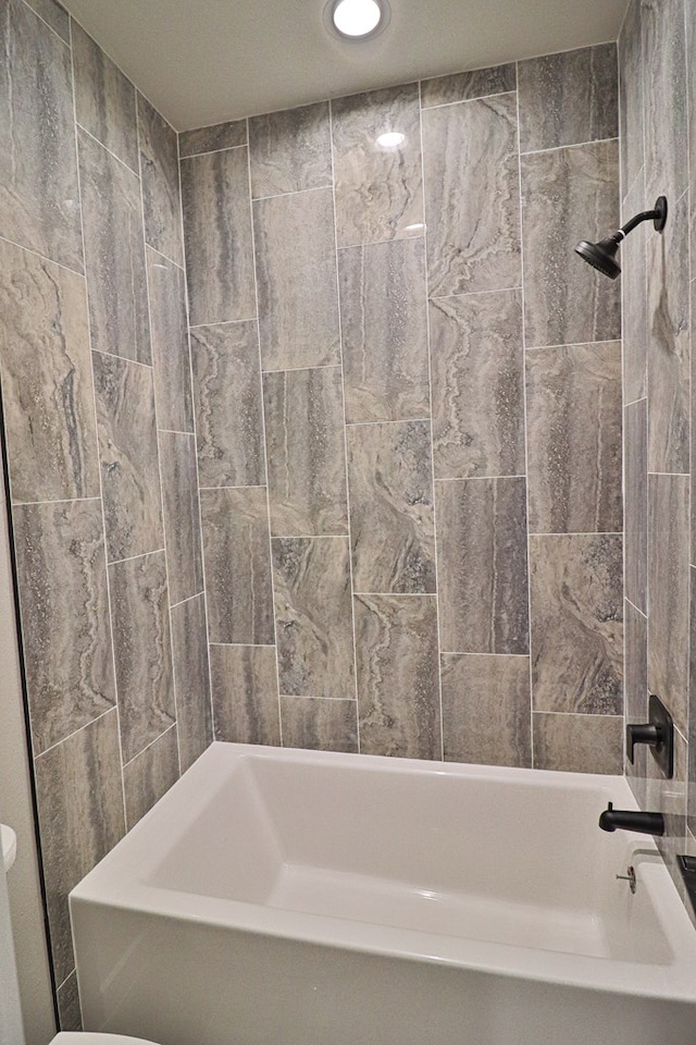 bathroom featuring recessed lighting and shower / tub combination