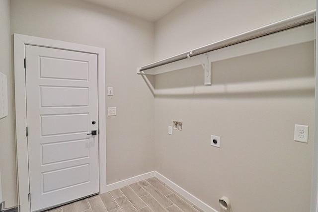 laundry area with hookup for an electric dryer, laundry area, wood finish floors, washer hookup, and baseboards