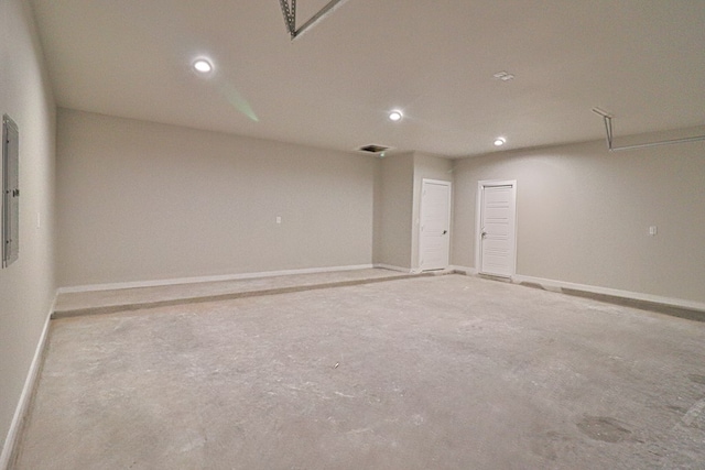 spare room featuring electric panel, baseboards, and recessed lighting