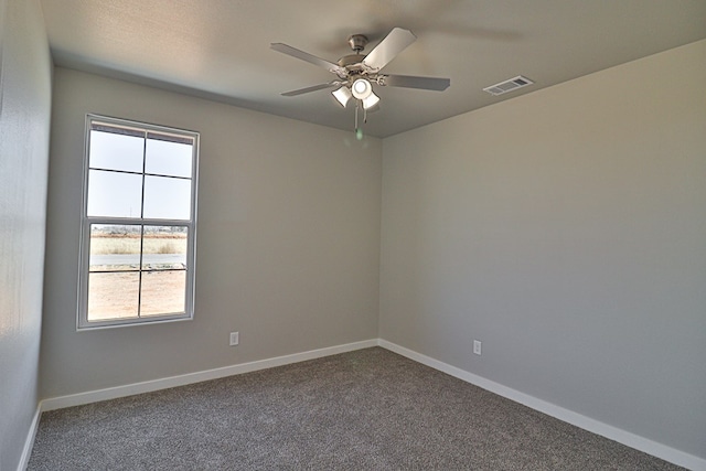 unfurnished room with carpet floors, baseboards, visible vents, and ceiling fan