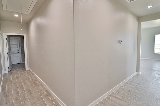 corridor with baseboards, recessed lighting, attic access, and wood tiled floor