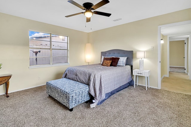 bedroom featuring ceiling fan, carpet flooring, visible vents, and baseboards