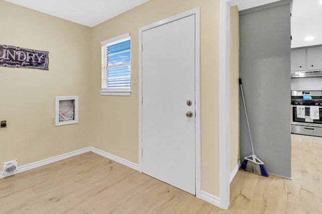 washroom with baseboards, laundry area, light wood-style flooring, and hookup for an electric dryer