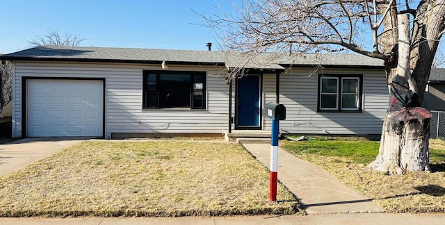 single story home with a garage, a front yard, and driveway