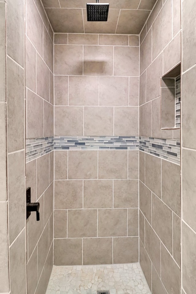 full bath featuring a tile shower