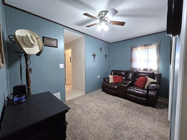 cinema room with light carpet, a textured ceiling, and ceiling fan