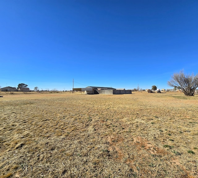 view of yard with a rural view