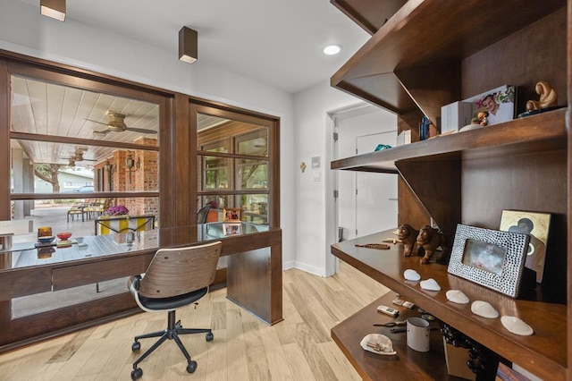 home office featuring ceiling fan and light hardwood / wood-style flooring