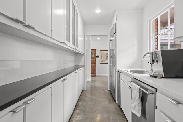 kitchen featuring white cabinetry, stainless steel dishwasher, and sink