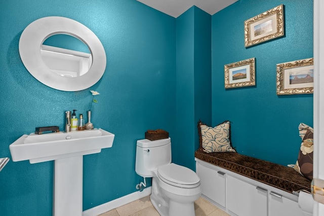 bathroom with tile patterned flooring, sink, and toilet