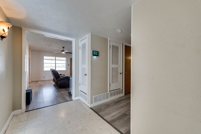 hallway featuring a textured ceiling