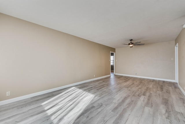 empty room featuring ceiling fan and light hardwood / wood-style floors