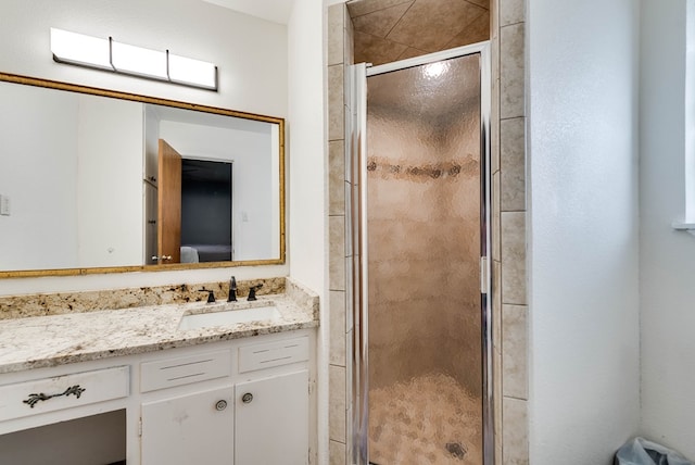 bathroom featuring walk in shower and vanity