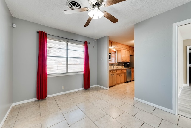 kitchen with ceiling fan, light tile patterned floors, dishwasher, and tasteful backsplash