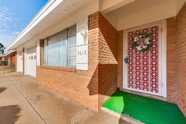 doorway to property featuring a garage