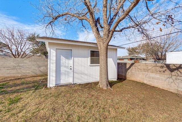 view of outbuilding featuring a lawn