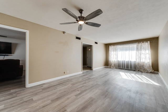 spare room featuring light wood-type flooring and ceiling fan