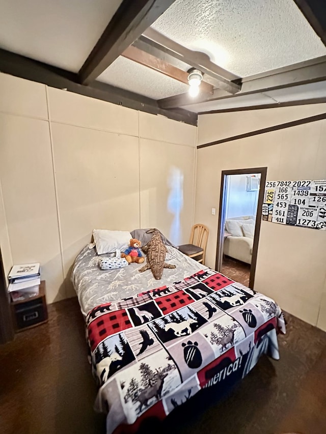 bedroom featuring beamed ceiling, ceiling fan, and a textured ceiling