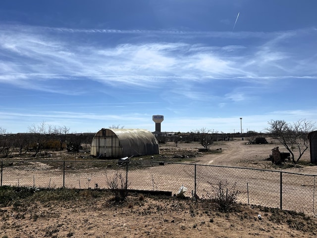 view of yard featuring an outbuilding and a rural view