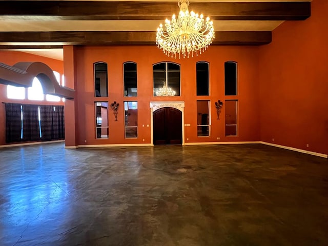 unfurnished living room featuring beamed ceiling and a notable chandelier