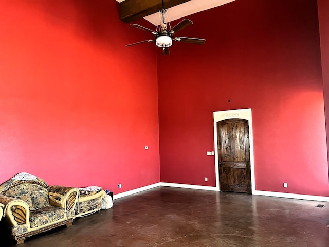 interior space featuring beam ceiling and ceiling fan