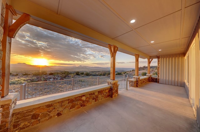 patio terrace at dusk with a mountain view and a porch