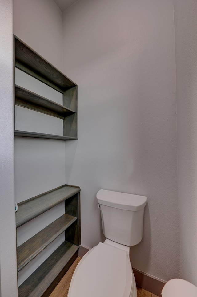 bathroom featuring wood-type flooring and toilet