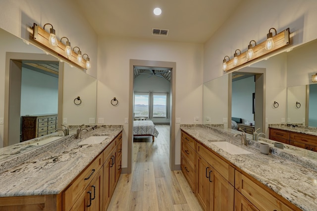 bathroom with vanity and hardwood / wood-style flooring