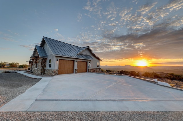 property exterior at dusk featuring a mountain view and a garage