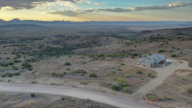 aerial view at dusk featuring a mountain view